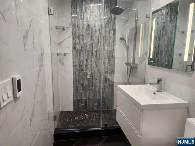 a bathroom with a shower and a sink