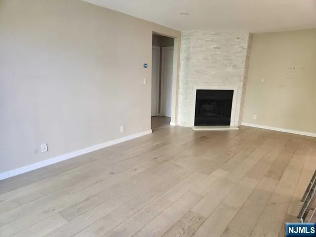 a view of an empty room with a fireplace