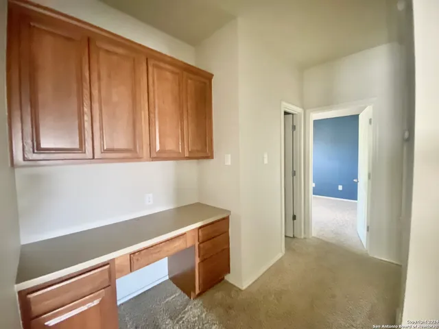 a view of hallway with cabinets