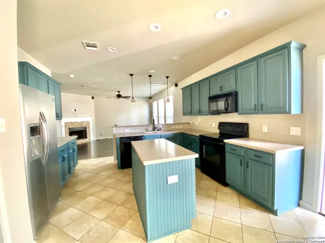 a kitchen with stainless steel appliances granite countertop a sink counter space and cabinets