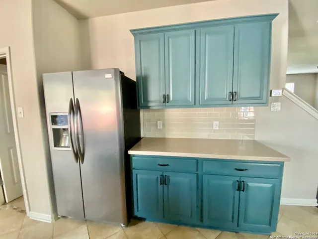 a kitchen with cabinets and stainless steel appliances