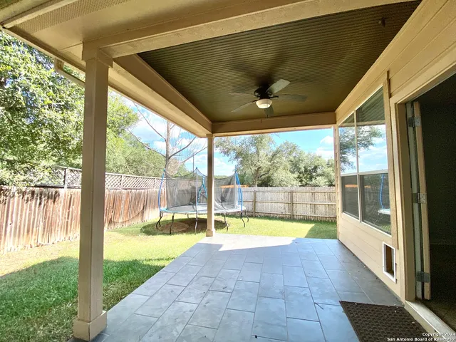 a view of swimming pool with a patio and yard