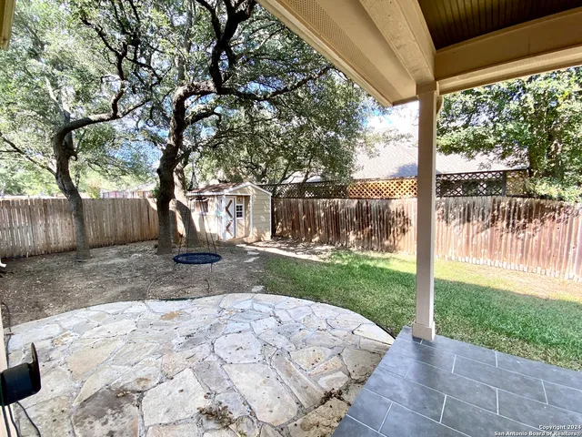 a view of a backyard with large tree