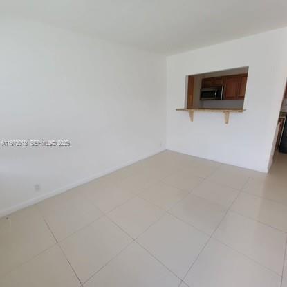 1845 Pembroke Road, Unit 322 Hollywood, FL 33020 - Photo 6 of 11 a view of a room with a flat screen tv