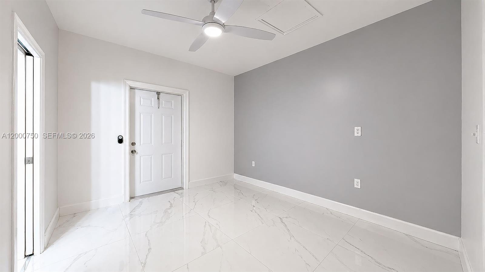 16247 Southwest 92nd Terrace, Unit B Miami, FL 33196 - Photo 15 of 17 an empty room with an entryway and fan
