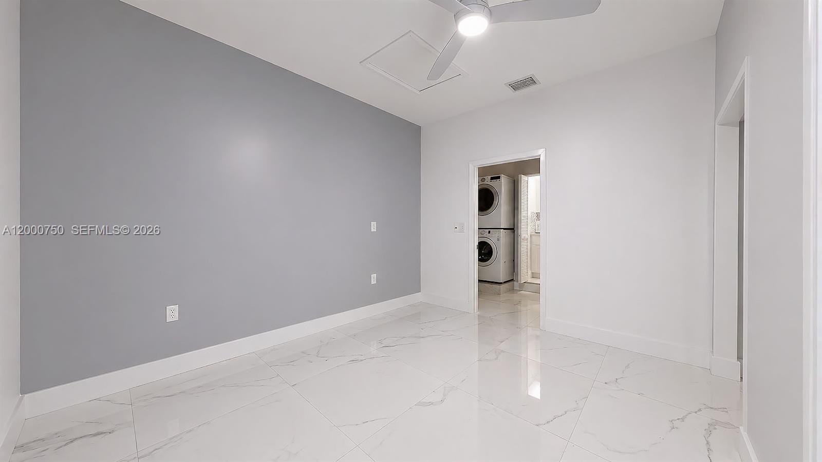 16247 Southwest 92nd Terrace, Unit B Miami, FL 33196 - Photo 4 of 17 an empty room with an entryway and chandelier fan