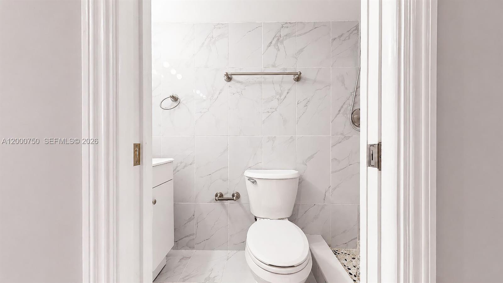 16247 Southwest 92nd Terrace, Unit B Miami, FL 33196 - Photo 6 of 17 a white toilet sitting next to a bathroom sink