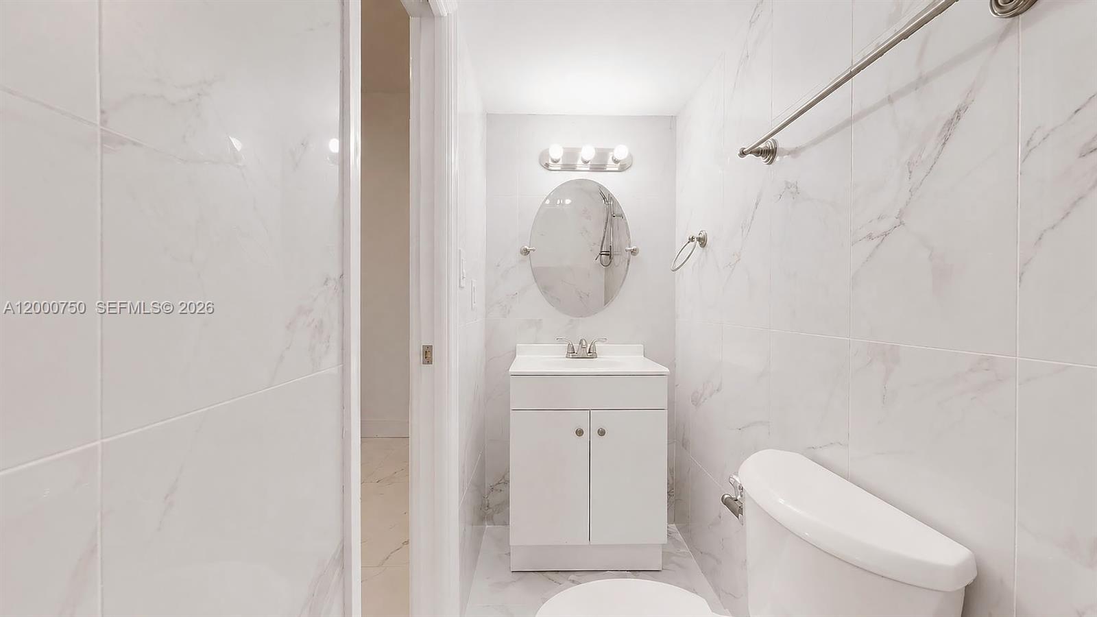 16247 Southwest 92nd Terrace, Unit B Miami, FL 33196 - Photo 8 of 17 a bathroom with a toilet a sink and mirror