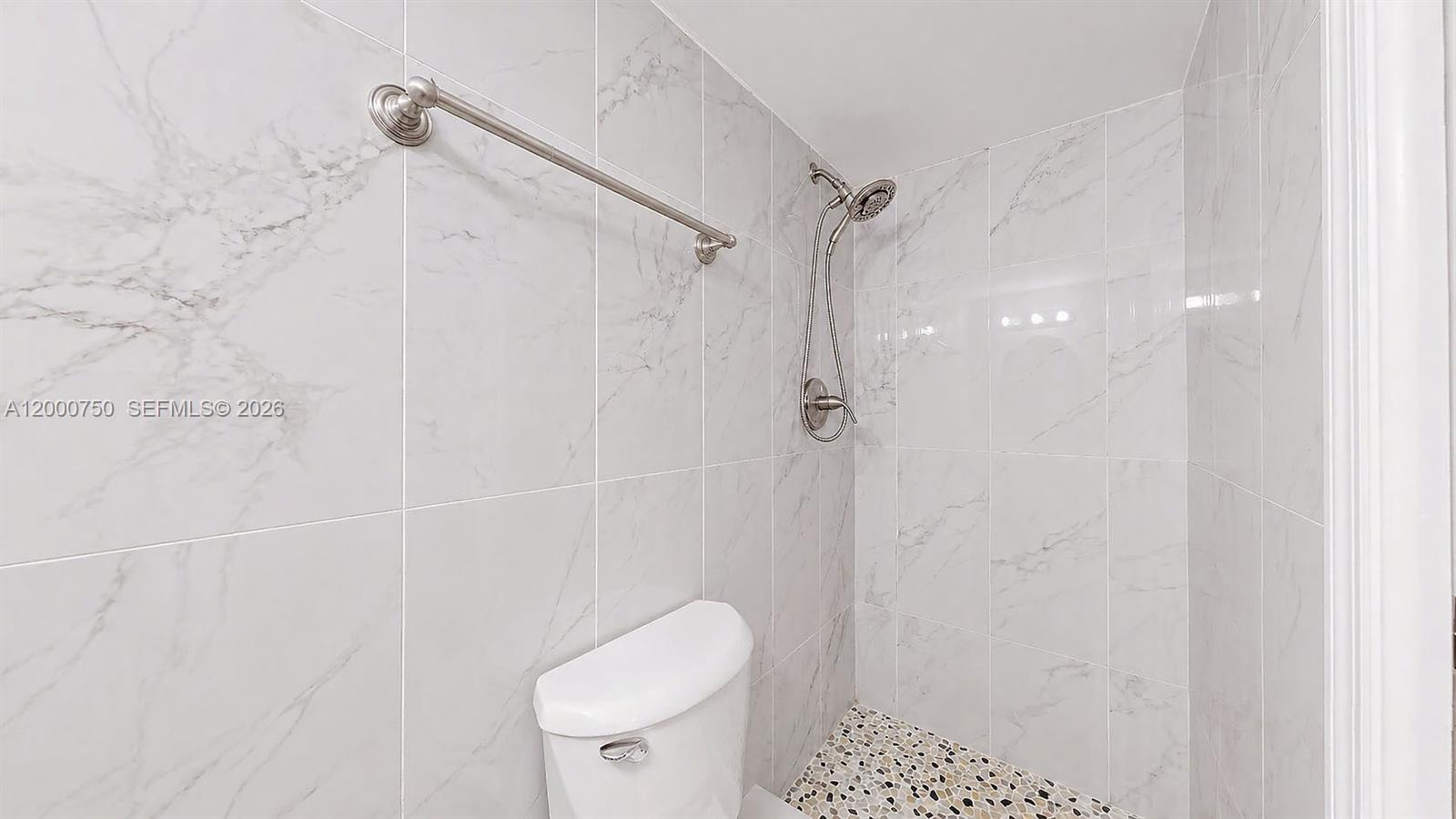 16247 Southwest 92nd Terrace, Unit B Miami, FL 33196 - Photo 10 of 17 a bathroom with a shower a toilet and a shower