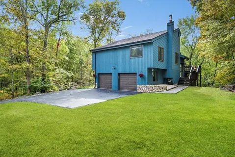 a backyard of a house with table and chairs