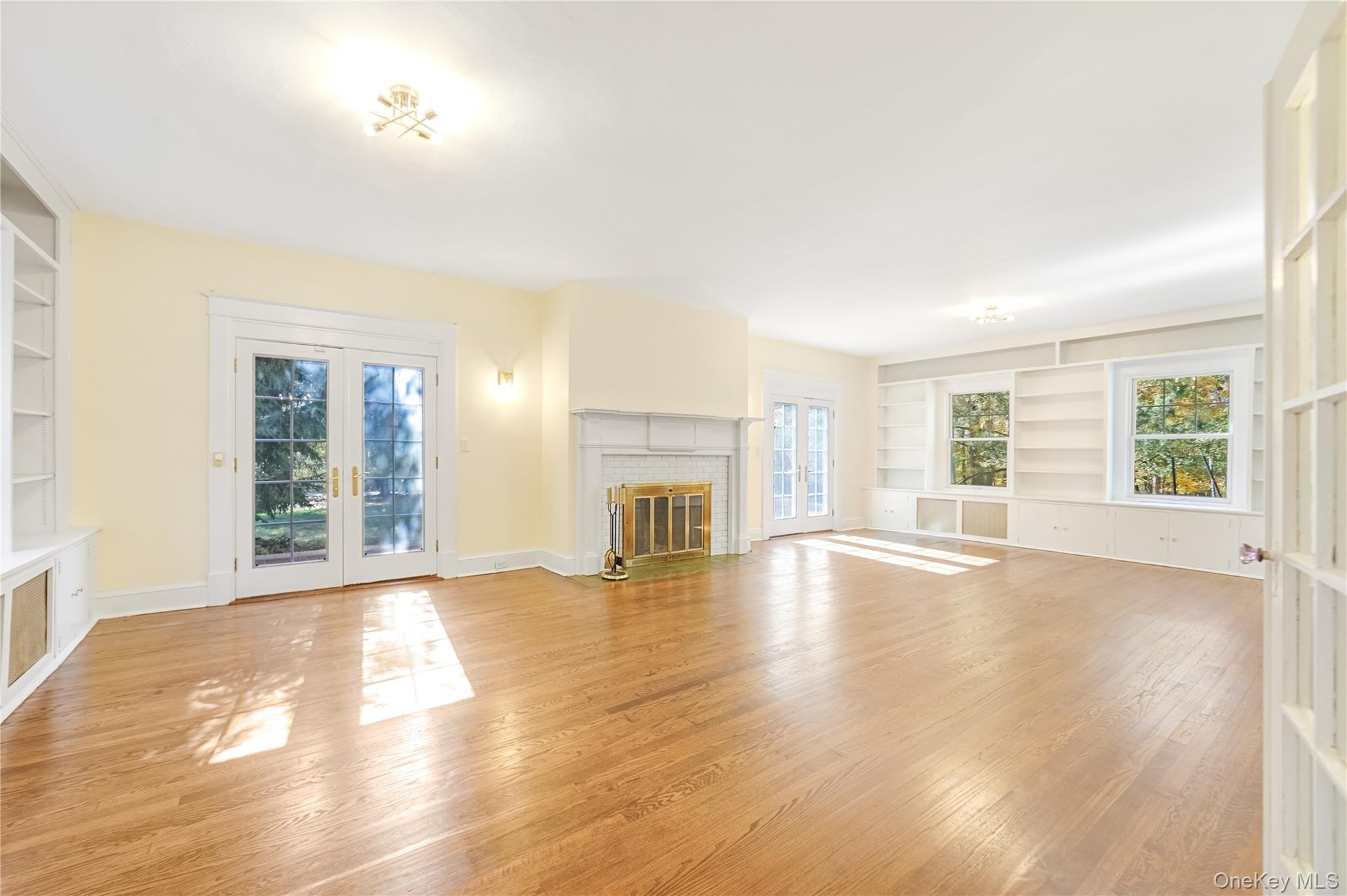 25 Whittier Road Blauvelt, NY 10913 - Photo 7 of 34 an empty room with wooden floor fireplace and windows