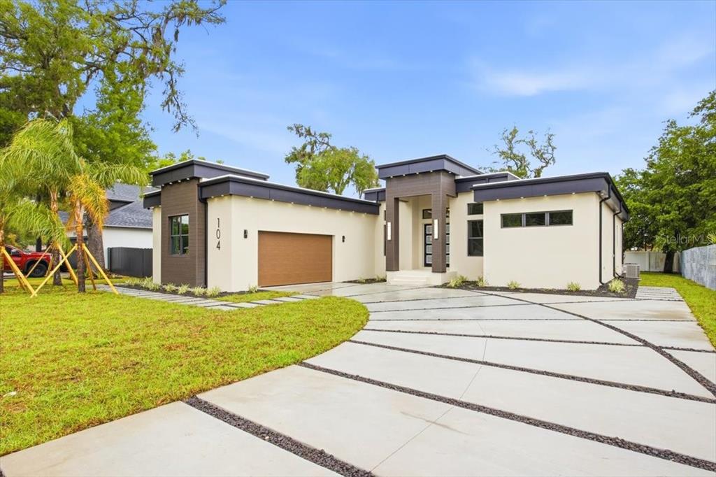 a front view of a house with a garden and yard