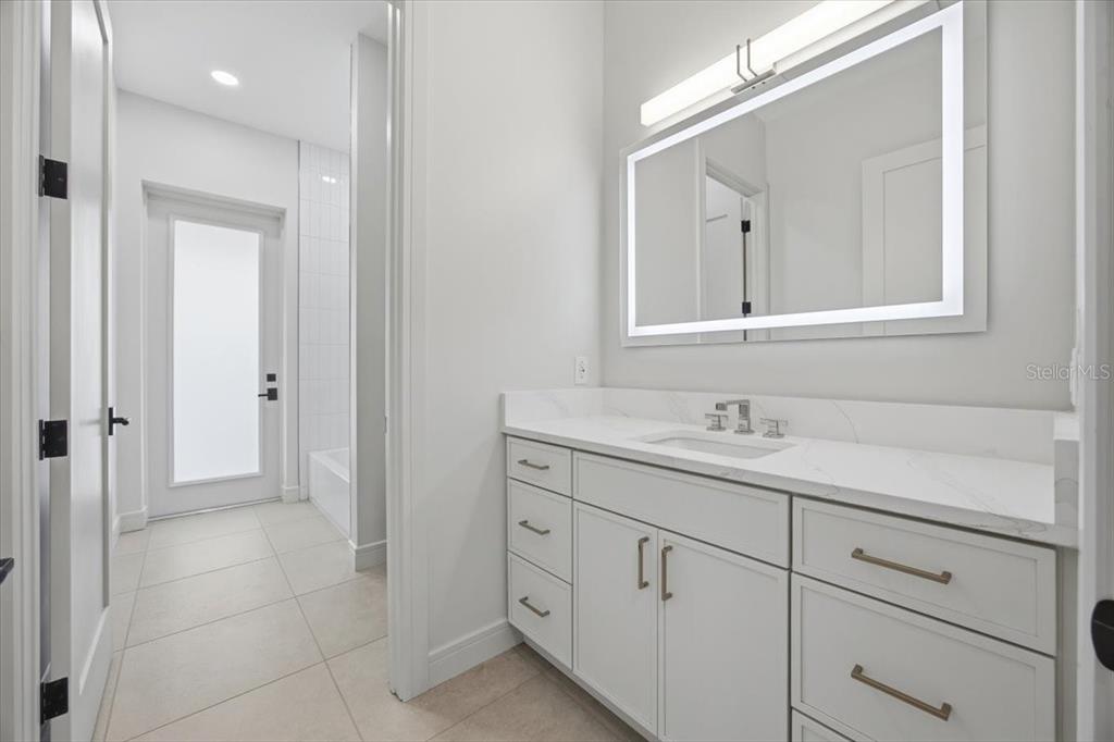 104 South Maki Road Plant City, FL 33563 - Photo 16 of 28 a bathroom with a granite countertop sink vanity and mirror