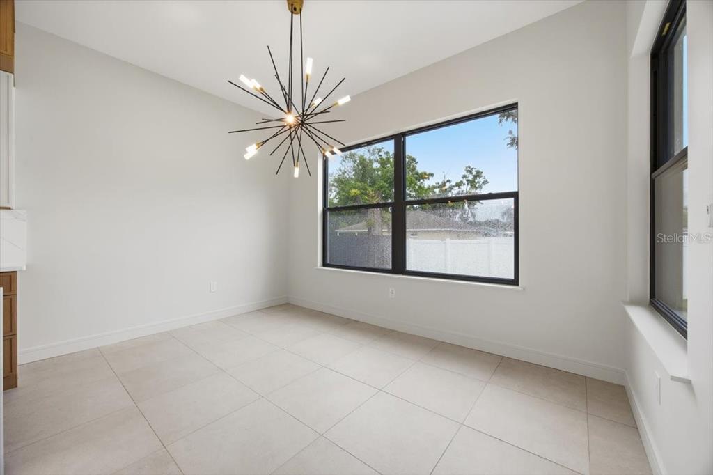 104 South Maki Road Plant City, FL 33563 - Photo 18 of 28 a view of an empty room with a window and kitchen view