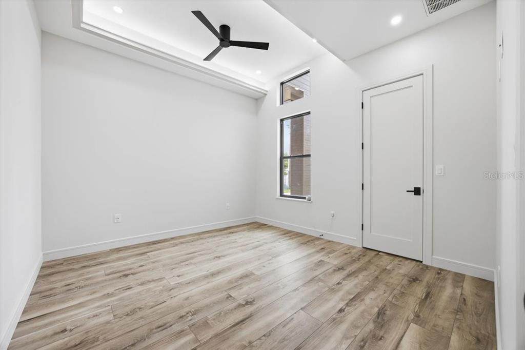 104 South Maki Road Plant City, FL 33563 - Photo 20 of 28 a view of empty room with wooden floor and fan