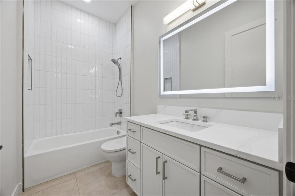 104 South Maki Road Plant City, FL 33563 - Photo 21 of 28 a bathroom with a sink a toilet and shower