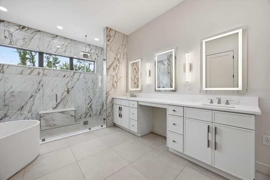 104 South Maki Road Plant City, FL 33563 - Photo 3 of 28 a bathroom with a granite countertop sink mirror and bathtub