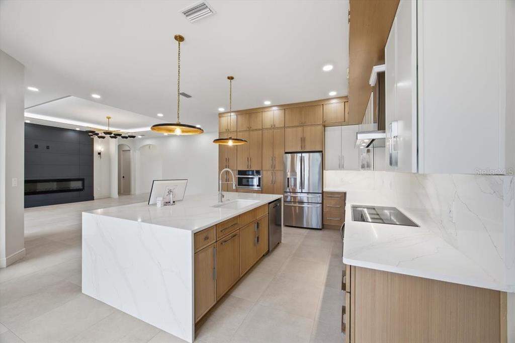 104 South Maki Road Plant City, FL 33563 - Photo 7 of 28 a kitchen with a sink a counter top space stainless steel appliances and cabinets