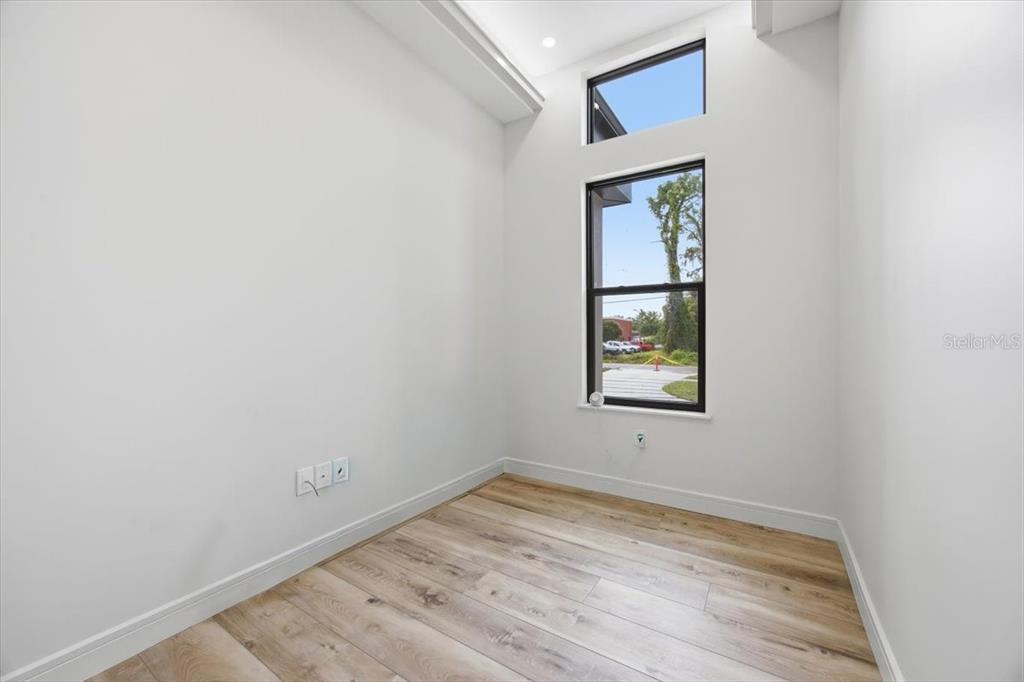 104 South Maki Road Plant City, FL 33563 - Photo 10 of 28 a view of an empty room with wooden floor and a window