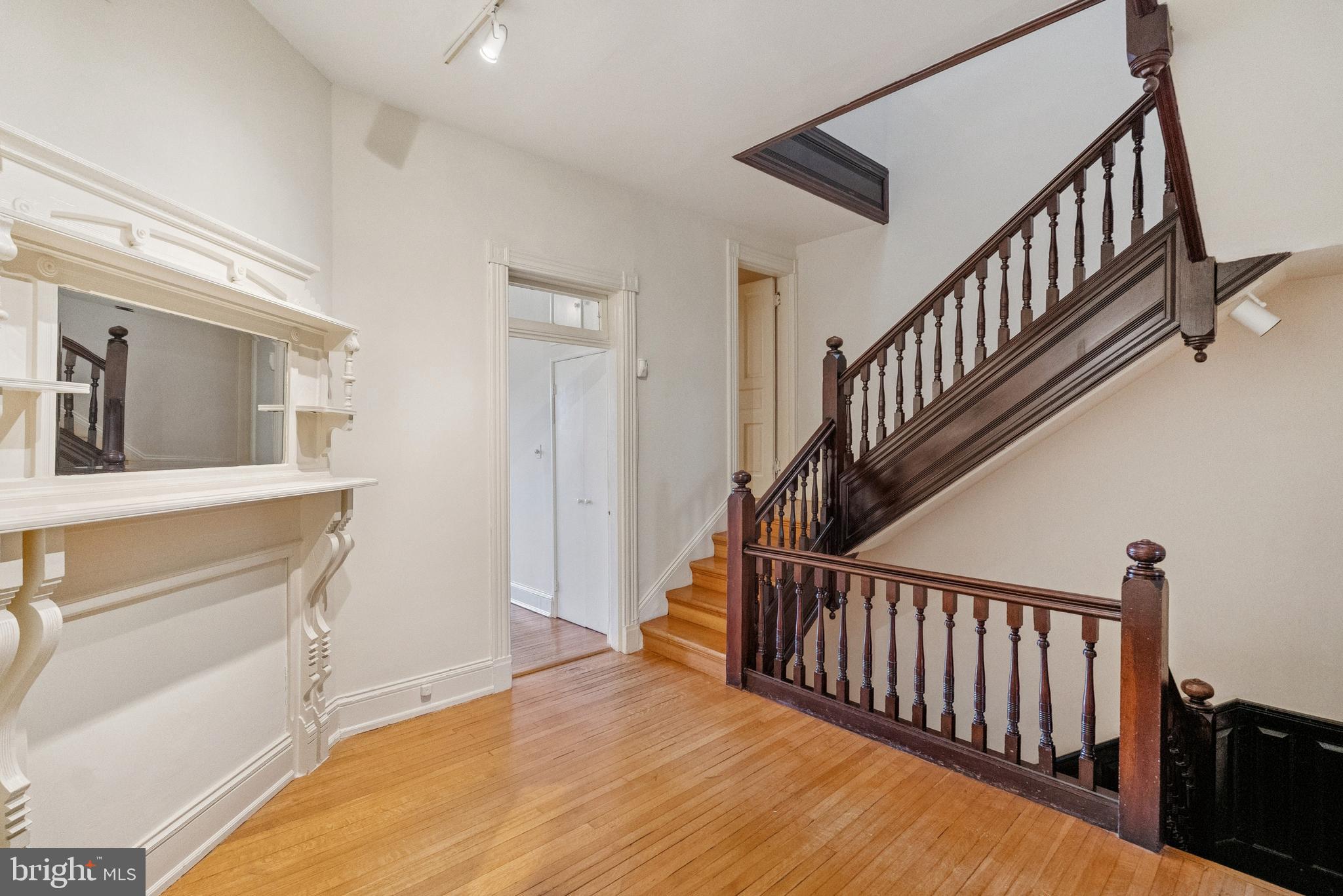 2012 R Street Northwest Washington, DC 20009 - Photo 11 of 31 a view of a hallway with wooden floor and staircase