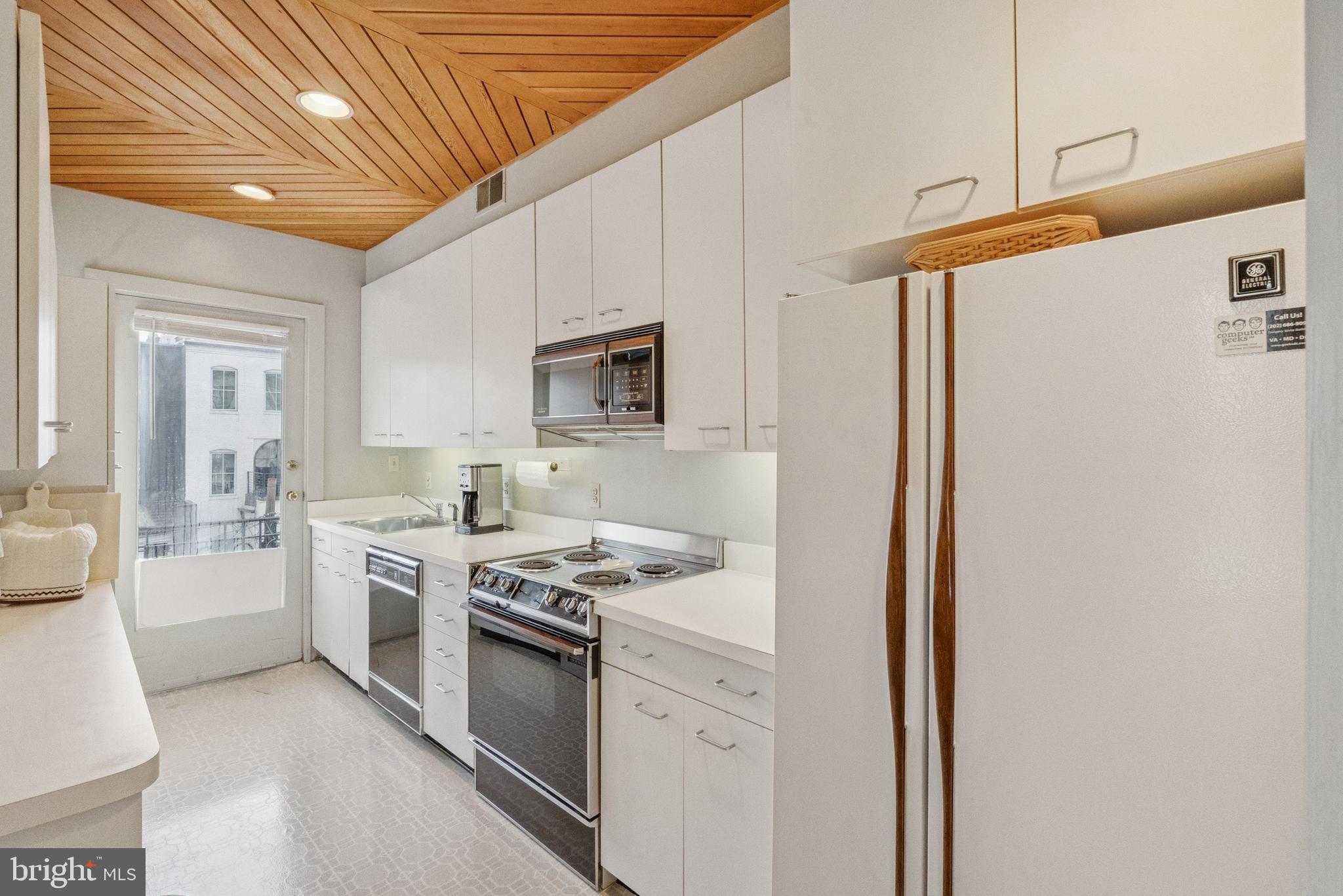 2012 R Street Northwest Washington, DC 20009 - Photo 16 of 31 a kitchen with stainless steel appliances a stove a sink and white cabinets