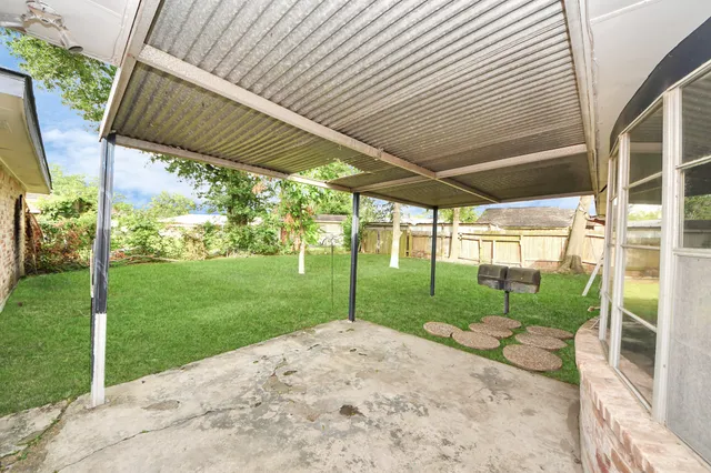 a view of a backyard with plants and a backyard