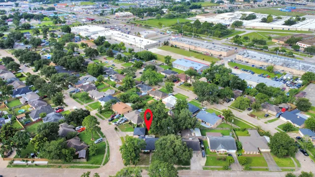 an aerial view of residential houses with outdoor space and swimming pool