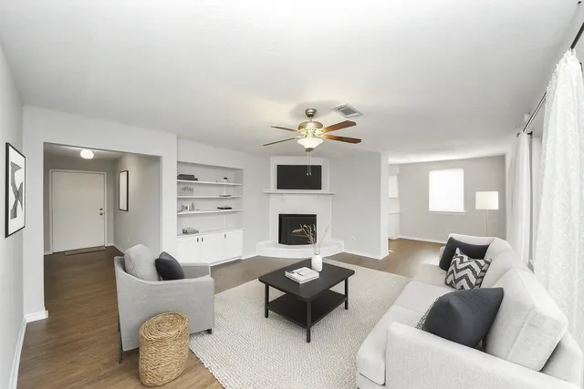 a living room with furniture and a fireplace