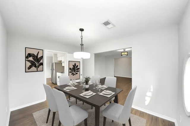 a view of a dining room a furniture and a table