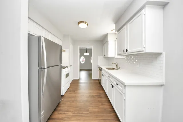 a kitchen with white cabinets