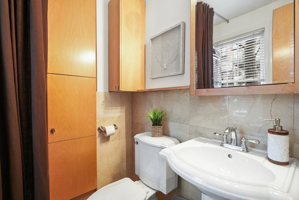 33 East Springfield Street, Unit 1 Boston, MA 02118 - Photo 12 of 31 a bathroom with a sink a toilet and mirror