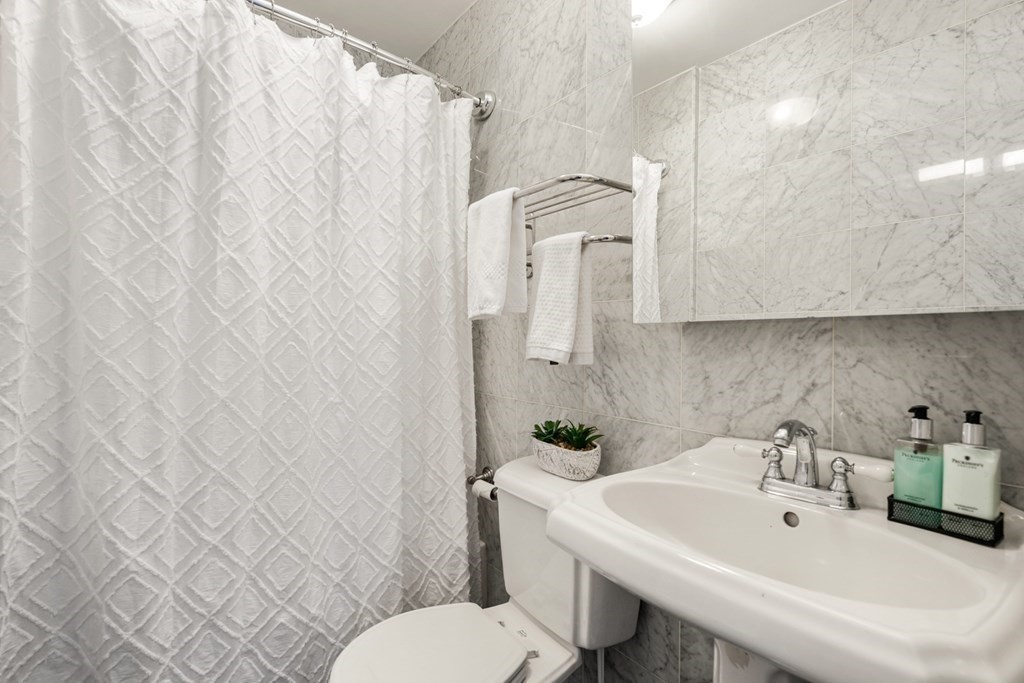 33 East Springfield Street, Unit 1 Boston, MA 02118 - Photo 22 of 31 a bathroom with a sink a toilet and a mirror