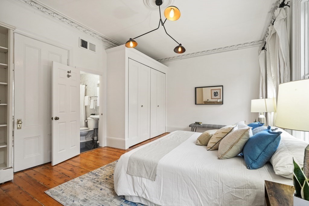33 East Springfield Street, Unit 1 Boston, MA 02118 - Photo 23 of 31 a bedroom with a bed and wooden floor
