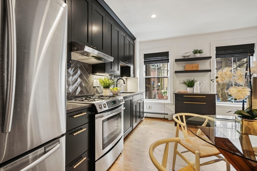 33 East Springfield Street, Unit 1 Boston, MA 02118 - Photo 26 of 31 a kitchen with stainless steel appliances granite countertop a stove top oven a sink and a refrigerator