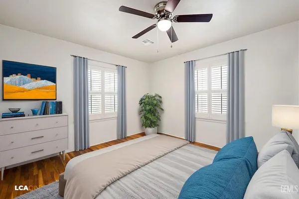 a view of empty room with wooden floor and fireplace