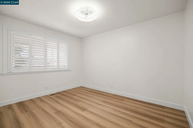 a bedroom with bed and a potted plant