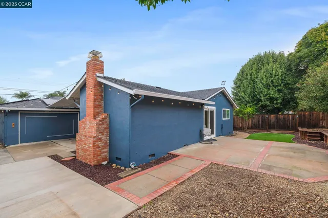 a view of backyard with wooden fence