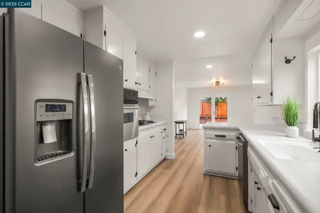 a kitchen with a sink cabinets and wooden floor