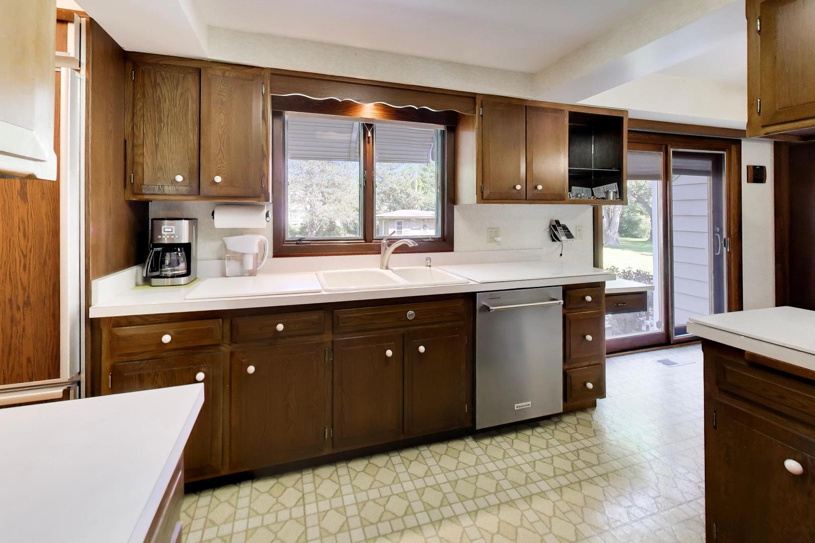 103 Cottonwood Road Northbrook, IL 60062 - Photo 11 of 50 a kitchen with a sink a stove and cabinets