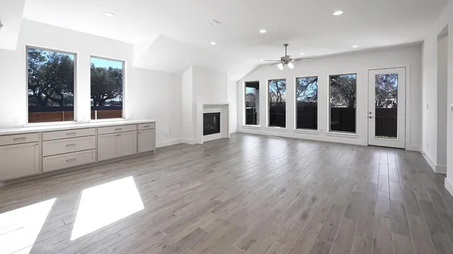 a kitchen with granite countertop a sink a stove and cabinets