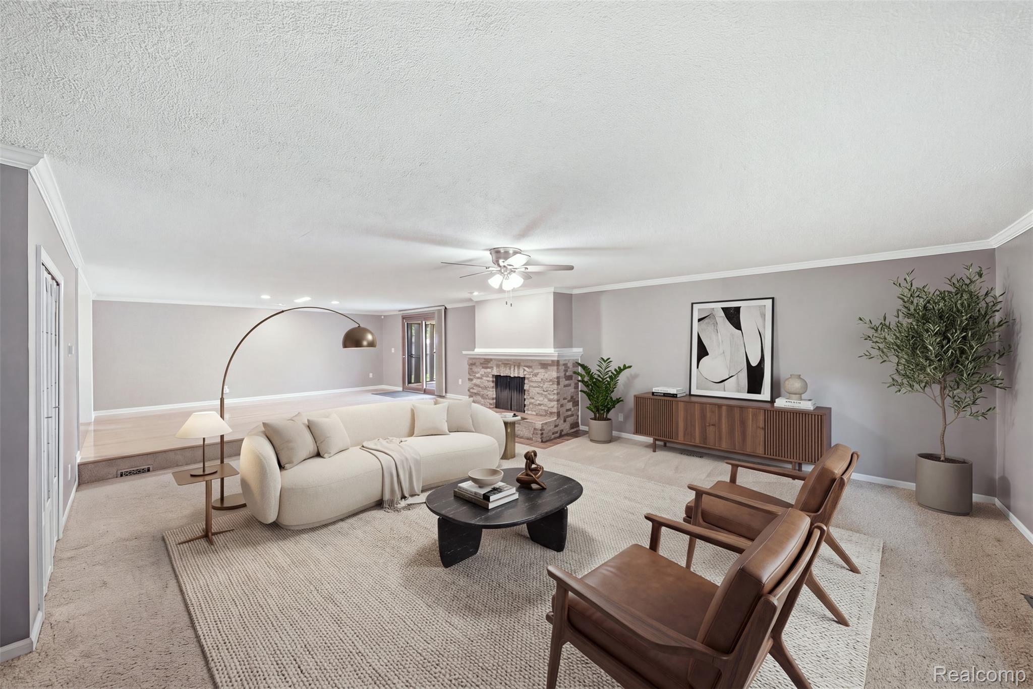 1087 Collingwood Drive Rochester, MI 48307 - Photo 26 of 56 Spacious living area featuring a stone-clad fireplace, a ceiling fan with integrated lighting, and crown molding