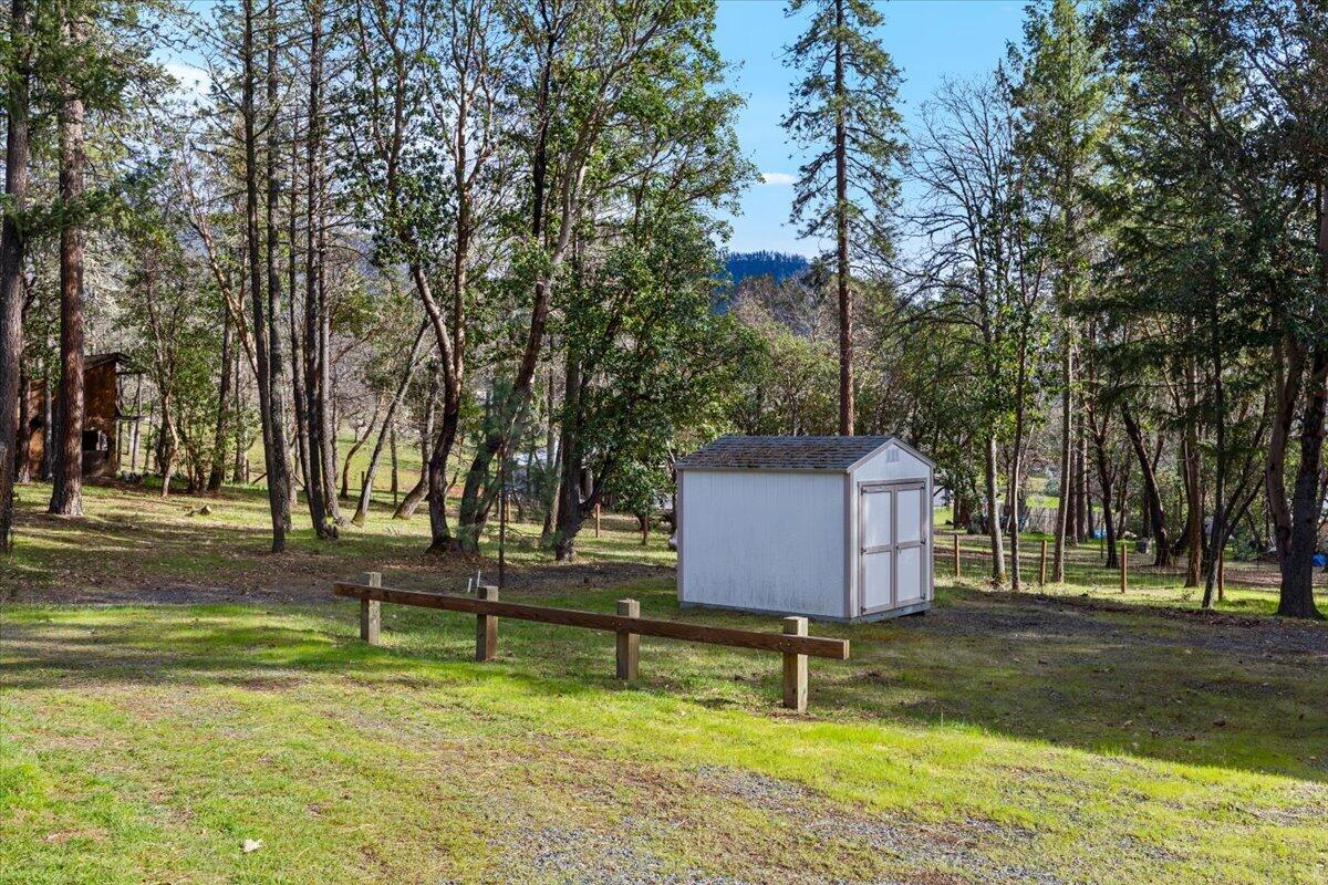 324 China Gulch Road Jacksonville, OR 97530 - Photo 38 of 45 a bench is sitting in the middle of a yard