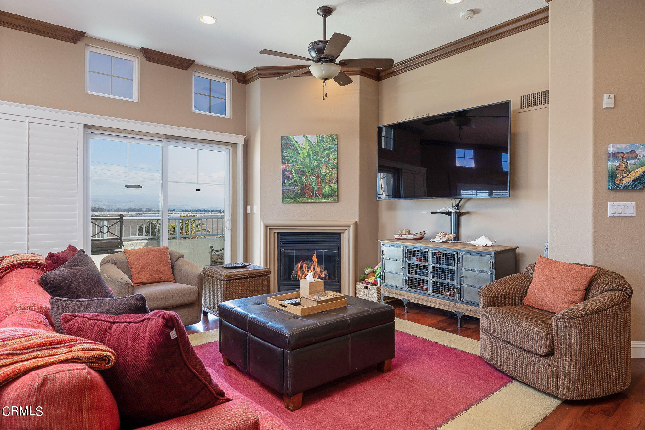 4288 Tradewinds Drive Oxnard, CA 93035 - Photo 1 of 42 a living room with furniture a flat screen tv and a fireplace
