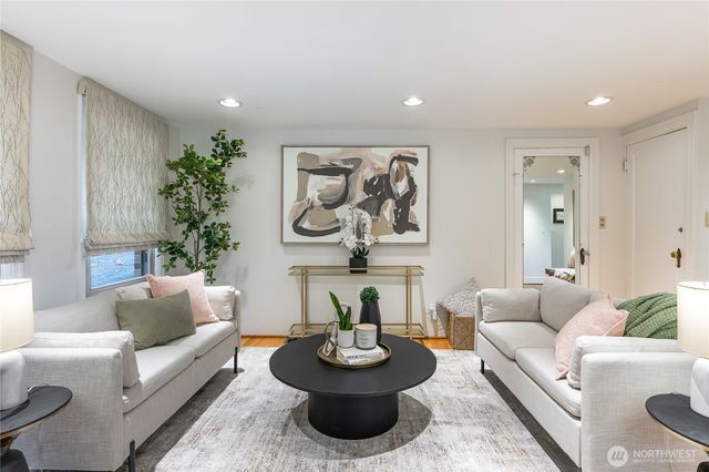 a living room with furniture and a potted plant