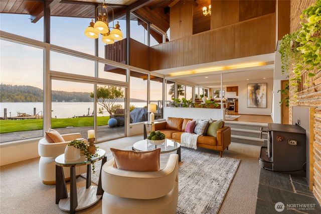 a living room with furniture and a floor to ceiling window