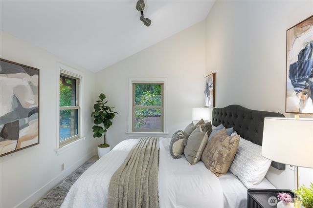 a bedroom with a bed and a potted plant