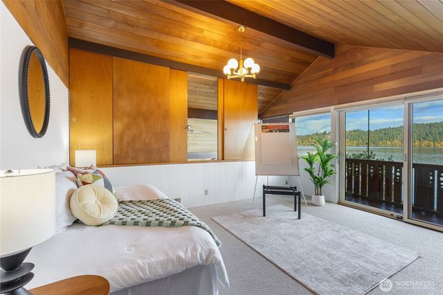 a bedroom with a bed and a large window