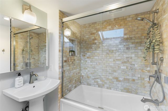 a bathroom with a shower and a sink