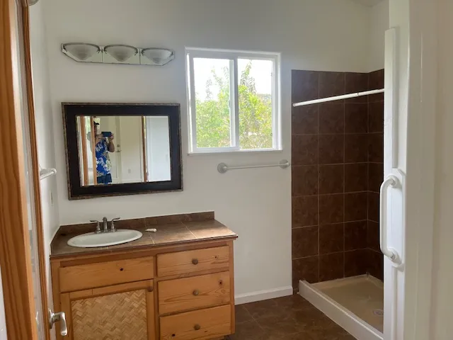 a kitchen with a sink a counter top space and cabinets