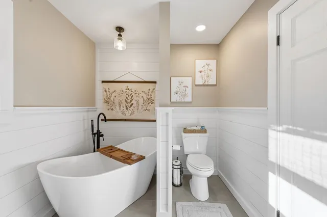 a front view of a building with large trees